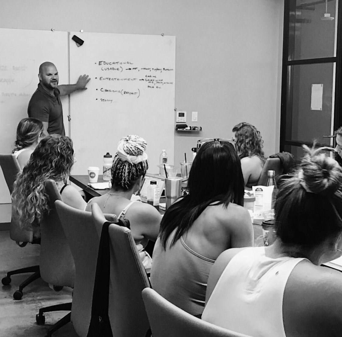 Dr. Jade Teta at a whiteboard, drawing the identity map for a room of practitioners